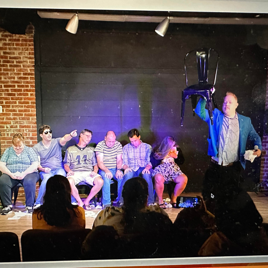 Jobeth Bowers hypnosis show with audience members on stage holding a chair